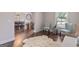 Bright living room with hardwood floors, stylish seating, and a view into the dining area at 2307 Loughridge Dr, Buford, GA 30519