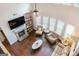 Open living room showcases fireplace, large windows, ceiling fan and hardwood flooring at 2307 Loughridge Dr, Buford, GA 30519