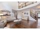 Open concept living room with a view of the kitchen and staircase and hardwood floors at 2307 Loughridge Dr, Buford, GA 30519