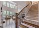 Bright living room boasts hardwood floors, fireplace, large windows, and an open staircase at 2307 Loughridge Dr, Buford, GA 30519