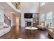 Open living room featuring a stone fireplace and hardwood floors with lots of natural light at 2307 Loughridge Dr, Buford, GA 30519