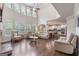 Expansive living room with two-story ceiling, fireplace, and views into the kitchen at 2307 Loughridge Dr, Buford, GA 30519