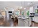 Open-concept living space combining kitchen, dining, and living areas with hardwood floors and ample natural light at 2307 Loughridge Dr, Buford, GA 30519