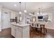 Open-concept living space combining kitchen, dining, and living areas with hardwood floors and natural light at 2307 Loughridge Dr, Buford, GA 30519