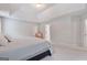 Bright primary bedroom featuring plush carpeting and tray ceilings at 2307 Loughridge Dr, Buford, GA 30519