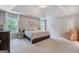 Spacious primary bedroom featuring plush carpeting, tray ceilings, and large windows at 2307 Loughridge Dr, Buford, GA 30519