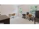 Well-lit office space with two desks, chairs, and dual windows providing natural light at 2307 Loughridge Dr, Buford, GA 30519