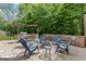 Outdoor patio area featuring stone seating, blue Adirondack chairs, and a built-in grill area at 2307 Loughridge Dr, Buford, GA 30519