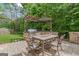 Entertaining patio with stone barbeque, outdoor table and chairs, and pergola for shade at 2307 Loughridge Dr, Buford, GA 30519
