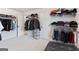 Large walk-in closet with clothing racks and a plush ottoman for comfortable dressing at 2307 Loughridge Dr, Buford, GA 30519
