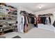Spacious walk-in closet with installed racks for multiple clothing items and rows of shoes on shelving at 2307 Loughridge Dr, Buford, GA 30519
