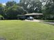 Charming brick home featuring a carport and a well-manicured front yard with mature trees at 537 Elizabeth Sw Ln, Mableton, GA 30126