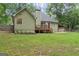 Backyard showcasing a well-kept lawn and an inviting deck area, ideal for outdoor relaxation at 15 Stonewood Way, Sharpsburg, GA 30277