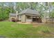 Backyard showcasing a well-kept lawn and an inviting deck area, ideal for outdoor relaxation at 15 Stonewood Way, Sharpsburg, GA 30277