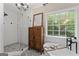 Beautiful bathroom featuring a glass shower, soaking tub, and decorative tile at 15 Stonewood Way, Sharpsburg, GA 30277