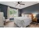 Serene bedroom with a queen-sized bed, wood floors, ample natural light, and a calming color scheme at 15 Stonewood Way, Sharpsburg, GA 30277