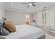 Calming main bedroom features tray ceiling, large window, and ensuite bathroom access at 15 Stonewood Way, Sharpsburg, GA 30277