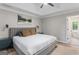 This stylish main bedroom boasts a tray ceiling, neutral tones, and ensuite bathroom access at 15 Stonewood Way, Sharpsburg, GA 30277