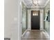 Inviting home foyer featuring wood flooring, neutral colors, and eye catching light fixture at 15 Stonewood Way, Sharpsburg, GA 30277