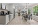 Bright eat-in kitchen boasts stainless appliances, modern cabinetry, and backyard views at 15 Stonewood Way, Sharpsburg, GA 30277