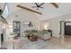 Open living room with beamed ceiling, cozy fireplace, and seamless flow to other areas at 15 Stonewood Way, Sharpsburg, GA 30277