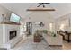 Inviting living room offering vaulted ceilings, wood beam detail, and cozy fireplace at 15 Stonewood Way, Sharpsburg, GA 30277