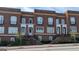 Brick townhomes feature black iron detailing, symmetrical windows, and raised entrances, adding to the curb appeal at 5139 Peachtree Road, Chamblee, GA 30341