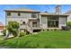 The backyard offers a lush lawn, a deck with stairs, and mature landscaping at 3835 Hickory Branch Trl, Suwanee, GA 30024