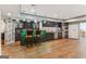 Finished basement featuring a wet bar with barstool seating, wine racks, custom cabinetry, and pendant lighting at 3835 Hickory Branch Trl, Suwanee, GA 30024