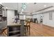 Basement bar with barstool seating, modern cabinetry, granite countertops, and hardwood floors at 3835 Hickory Branch Trl, Suwanee, GA 30024