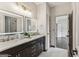 Bathroom featuring double vanity with marble countertops and backlit mirrors, and tile flooring at 3835 Hickory Branch Trl, Suwanee, GA 30024