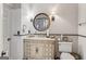 Charming bathroom featuring vintage-style vanity, marble countertops, and round decorative mirror at 3835 Hickory Branch Trl, Suwanee, GA 30024