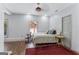 Bright bedroom with ceiling fan, hardwood floors, and natural light from the window at 3835 Hickory Branch Trl, Suwanee, GA 30024