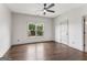 Bright bedroom with hardwood floors and a large window overlooking a lush backyard at 3835 Hickory Branch Trl, Suwanee, GA 30024