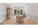 Bright dining room with hardwood floors, neutral walls, and a decorative chandelier above the dining table at 3835 Hickory Branch Trl, Suwanee, GA 30024