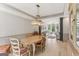 Bright dining room features modern chandelier, hardwood floors, and seamless access to a cozy living area at 3835 Hickory Branch Trl, Suwanee, GA 30024