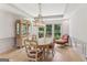 Elegant dining room with hardwood floors, neutral walls, decorative chandelier and furniture for a welcoming ambiance at 3835 Hickory Branch Trl, Suwanee, GA 30024