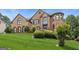 Attractive brick home with manicured lawn and mature landscaping at 3835 Hickory Branch Trl, Suwanee, GA 30024