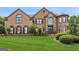 Charming brick home with a lush green lawn and mature trees at 3835 Hickory Branch Trl, Suwanee, GA 30024