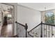 Foyer and staircase area with dark hardwood floors and a unique round chandelier at 3835 Hickory Branch Trl, Suwanee, GA 30024