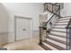 Welcoming foyer features hardwood floors, staircase with iron railing, and double doors at 3835 Hickory Branch Trl, Suwanee, GA 30024