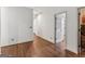 Hallway with dark hardwood floors that leads to other rooms in the home at 3835 Hickory Branch Trl, Suwanee, GA 30024