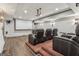 Home theater boasts a large projector screen, comfortable leather seating, and modern lighting for the ultimate entertainment space at 3835 Hickory Branch Trl, Suwanee, GA 30024