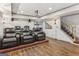 Home theater features tiered seating with leather recliners, wood-look flooring, and a projector for an immersive viewing experience at 3835 Hickory Branch Trl, Suwanee, GA 30024