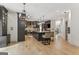 Spacious kitchen features dark cabinetry, a large center island with seating, and stainless steel appliances for modern convenience at 3835 Hickory Branch Trl, Suwanee, GA 30024