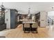 Modern kitchen with large island, dark cabinetry, stainless steel appliances, and stylish pendant lighting illuminating the space at 3835 Hickory Branch Trl, Suwanee, GA 30024