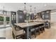 Spacious kitchen features a large island with marble countertop, seating, and dark cabinetry with modern appliances at 3835 Hickory Branch Trl, Suwanee, GA 30024