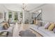 Open living room with hardwood floors, multiple seating areas, and lots of natural light at 3835 Hickory Branch Trl, Suwanee, GA 30024