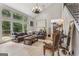 Spacious living room with hardwood floors, large windows, and comfortable seating at 3835 Hickory Branch Trl, Suwanee, GA 30024