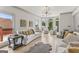 Open living room with hardwood floors, modern chandelier, and many windows at 3835 Hickory Branch Trl, Suwanee, GA 30024
